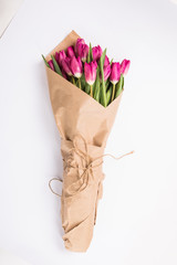 Pink tulips in a package of craft on the white background. Pink tulip. Tulips. Flowers. Flower background. Flowers photo concept. Holidays photo concept. Copyspace
