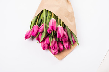 Pink tulips in a package of craft on the white background. Pink tulip. Tulips. Flowers. Flower background. Flowers photo concept. Holidays photo concept. Copyspace