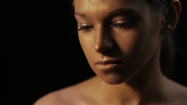 Creative art makeup - bronze woman face closeup