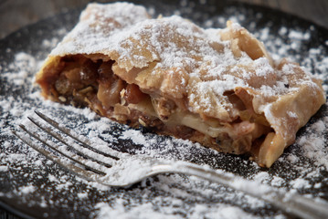 Fresh baked homemade apple strudel with powdered sugar