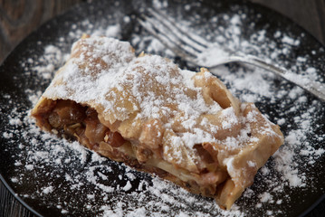 Fresh baked homemade apple strudel with powdered sugar