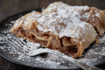 Fresh baked homemade apple strudel with powdered sugar