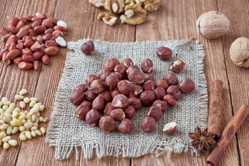Cinnamon sticks, anise, coffee beans and nuts on a wooden background