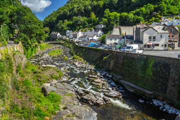 Fototapeta na wymiar View of the village of Lynmouth. East Lyn River. Clear weather. The day and the sun. North Devon. UK