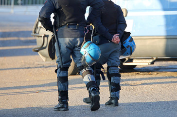 police in riot gear with protective helmet waiting for the fans