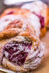Closeup of berry filled puff pastry danish with powdered sugar