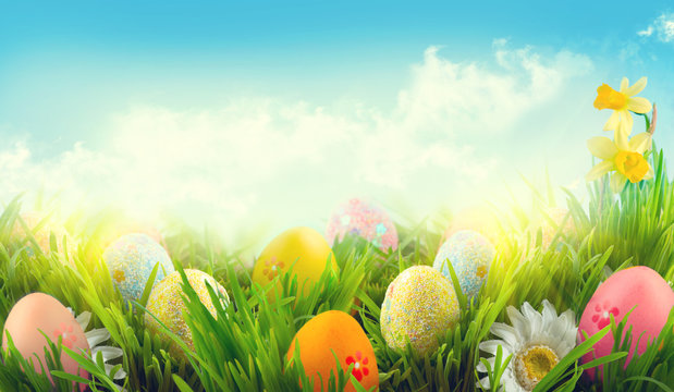 Easter nature spring scene background. Beautiful colorful eggs in spring grass meadow
