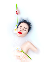 Beautiful Fashion model girl taking milk bath, spa and skincare concept