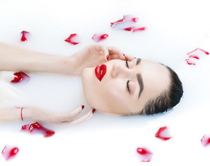 Obraz na płótnie Canvas Beautiful fashion model girl taking milk bath, spa and skincare concept