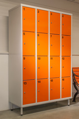 Orange color metal closet with lockers.