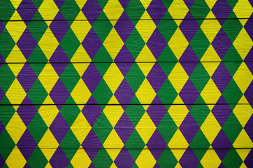 Diamond green, purple, yellow pattern painted Mardi Gras holiday background. Invitation, postcard, greeting card banner template. © mykolastock