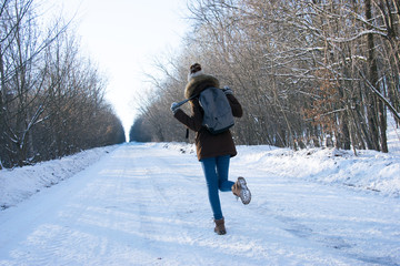 Walking girl in winter forest