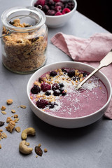 Healthy breakfast smoothie bowl with fresh berries and home made granola