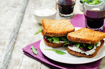 Roasted beet ricotta arugula rye sandwich