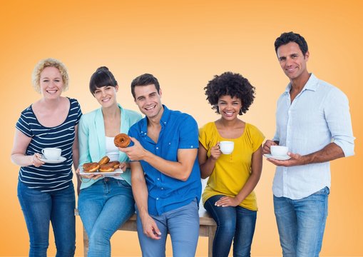 Happy group of people Eating donus against orange background