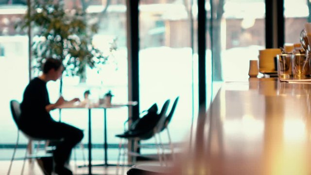 Defocused visitor and waiters in a modern cafe. 4K video