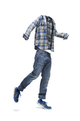 Jumping empty clothes. Checked shirt, worn jeans and blue trainers.