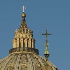 Fototapeta premium Dome of St Peter's, Vatican, at dawn, juxtaposed with cross on obelisk
