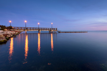 Obraz premium Wooden pier in Kuznica at dusk. Baltic Sea. Poland. 