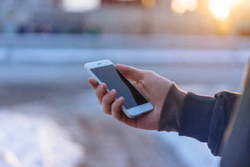 Close-up of male hands using modern smartphone outdoor, professional businessman typing text message on cell phone, Blurred background, Shallow DOF