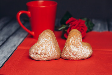 cupcakes sprinkled with powdered sugar, red mug and flower