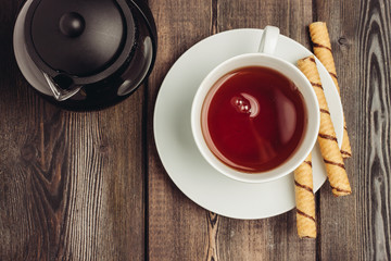 A light cup with a drink and a kettle