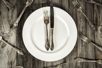 White empty plate on a gray wooden surface