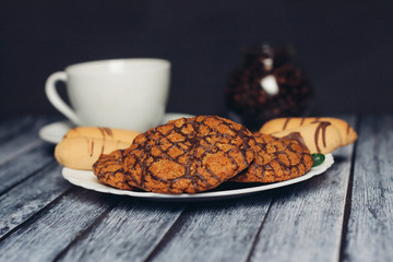 oatmeal cookies in chocolate glaze and a cup in the background