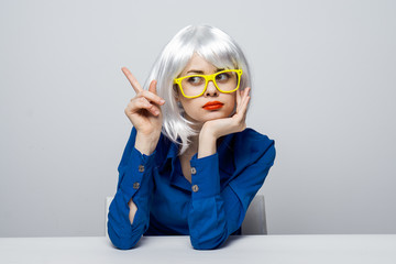 lady in yellow glasses shows Finger aside