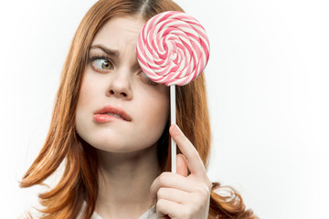 a woman closes her eyes with a large candy