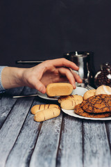 different cookies on a saucer on a wooden table