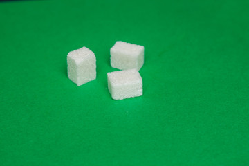 cubes of sugar on a green background