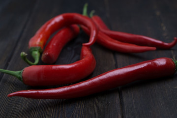 wooden background red hot chili peppers with vegetables