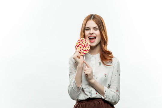 happy woman with a colorful lollipop