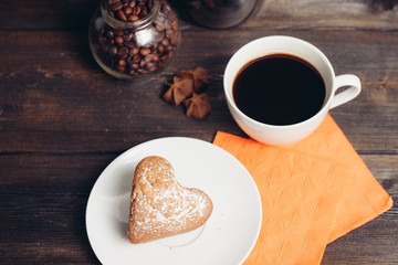 drink in a cup and a cupcake in a plate