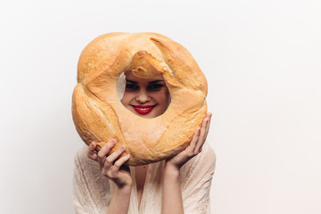 smiling woman looking into a round loaf