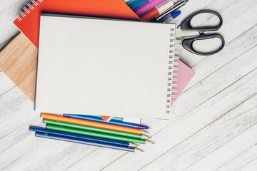 notebooks, pens, colorful pencils, scissors