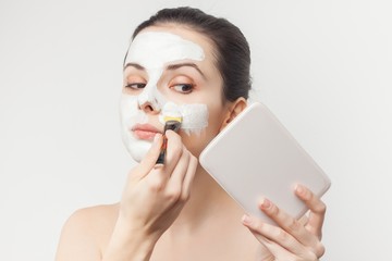 white face, mask for cleansing, woman with makeup brush