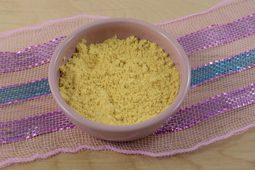 Ground mustard spice in pink condiment bowl