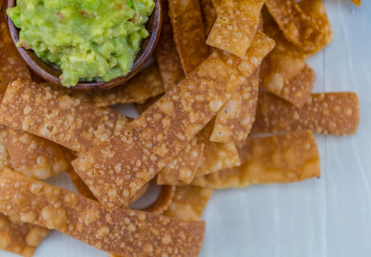 Texture of Homemade Chips with Guacamole in Top Left Corner