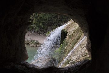 Fototapeta na wymiar Waterfall through a cave