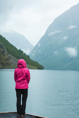 Tourist looking at mountains and fjord Norway, Scandinavia.