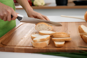 Close up of  woman's hands cooking in the kitchen. Housewife slicing ​​fresh salad. Vegetarian and healthily cooking concept