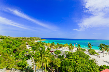 Stunning gorgeous beautiful, amazing view of Holguin province tropical inviting beach and tranquil azure turquoise ocean on blue sky background 