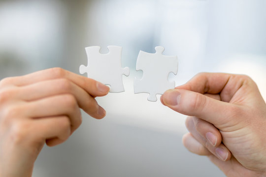 man and woman hand holding jigsaw puzzles, business matching concept
