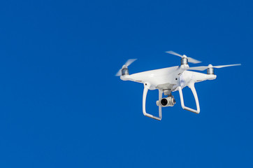 Quadrocopter drone with mounted digital camera for video and photo productions