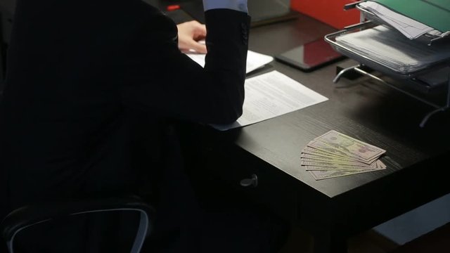 corruption, bribery and fraud concept - close up of businessman taking money
