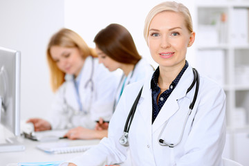Fototapeta premium Female doctor leading a medical team at the hospital