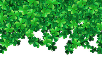 Saint Patricks day background with sprayed green clover leaves or shamrocks