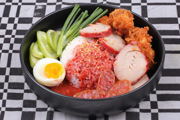 Jasmine rice with meat and boiled egg topped red sweet sauce .